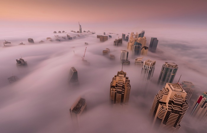 Dubai skyscrapers shrouded in fog at sunrise
