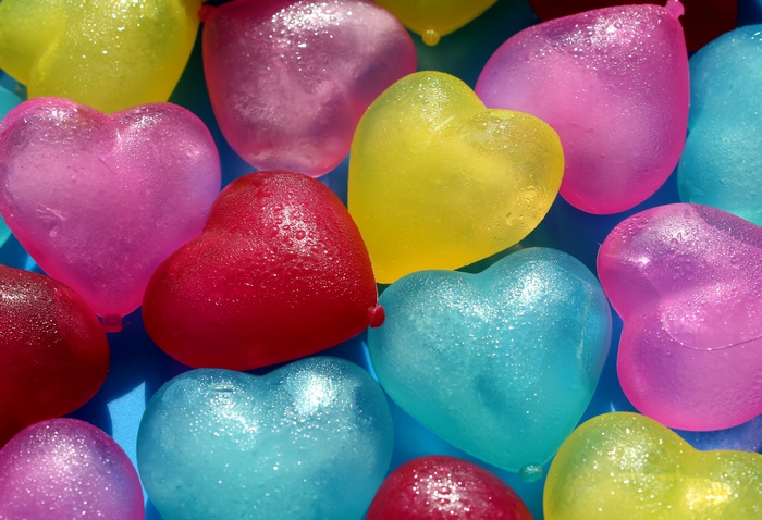 Heart-shaped ice cubes with water droplets