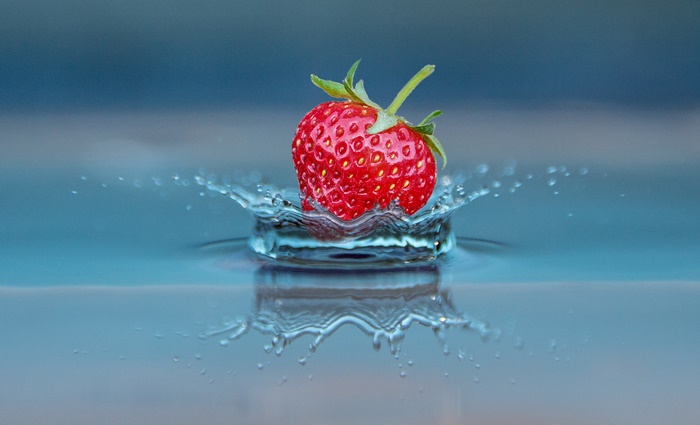 Strawberry splashing into water