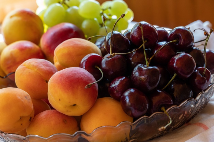 Fruit bowl with apricots, cherries, and grapes