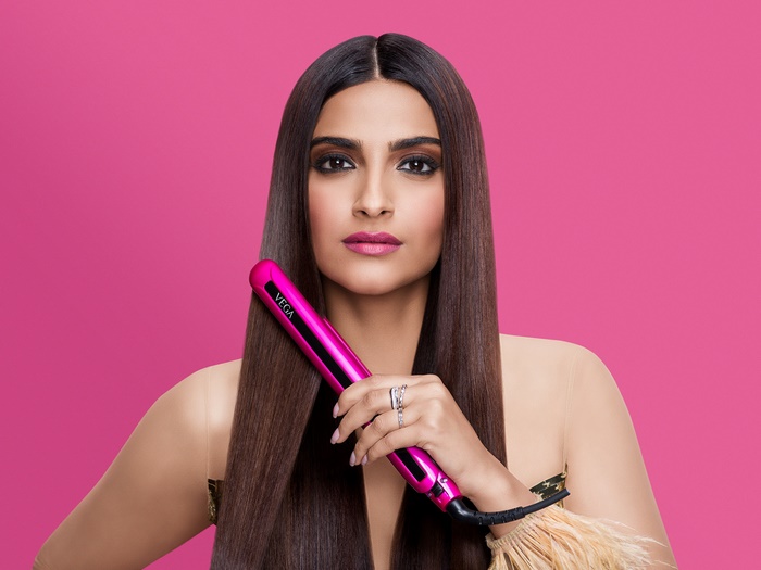 Sonam Kapoor with a pink Vega hair straightener