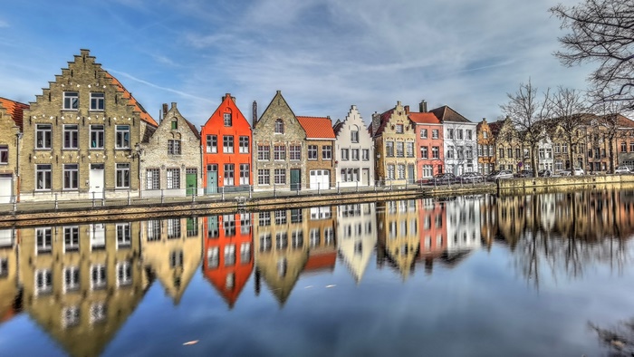 Bruges canal with colorful houses and reflections