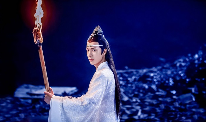Lan Wangji from The Untamed holding a torch
