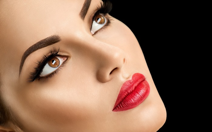 Woman with red lipstick and dramatic makeup