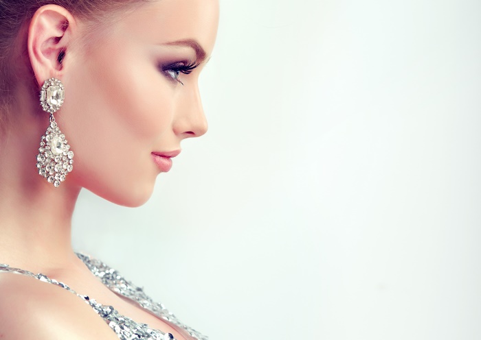 Elegant Model Profile with Makeup and Earrings in