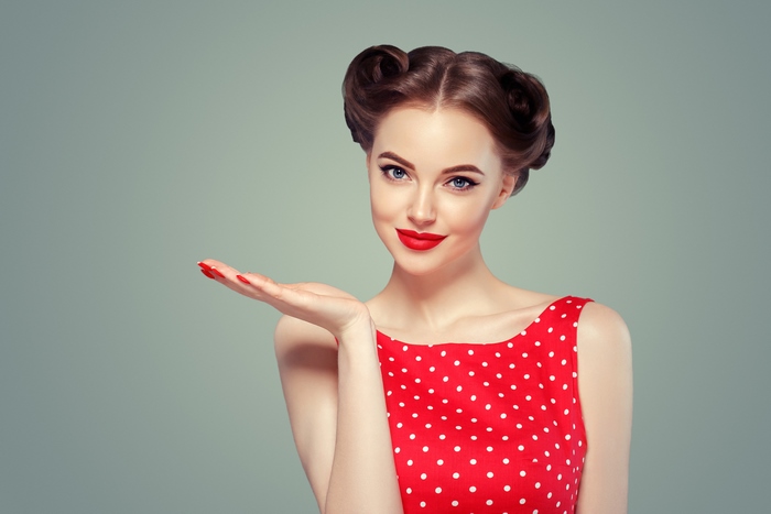Woman in red polka dot dress with retro hairstyle