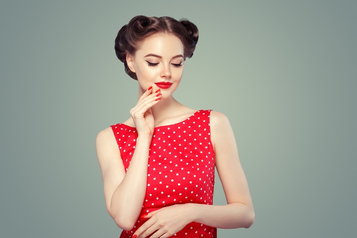Woman with retro hairstyle and red polka dot dress