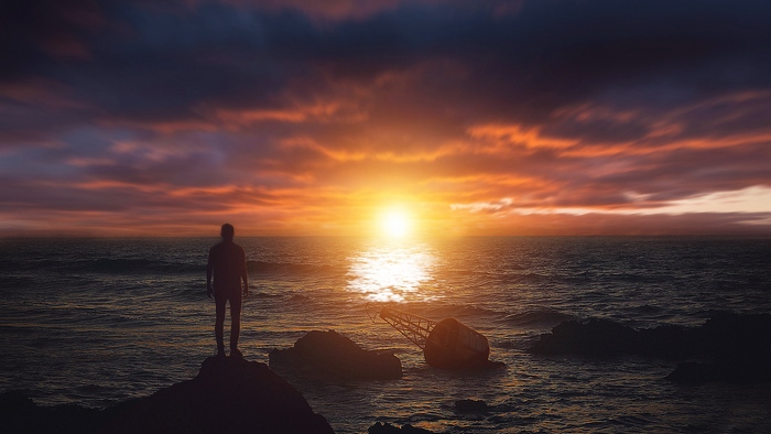 Man watching sunset over the sea