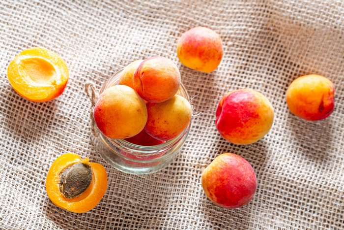 Apricots in a jar on burlap