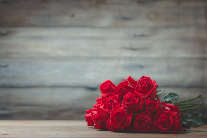 Bouquet of Red Roses on Wooden Background