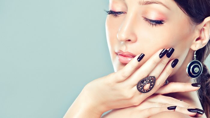 Woman with black nails and jewelry
