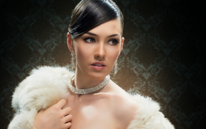 Elegant woman in fur and diamond jewelry