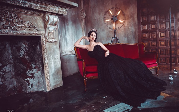 Model Alla Berger in black dress with crown