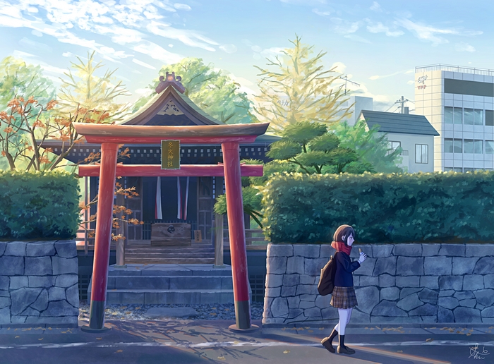 Girl in uniform walks past a shrine