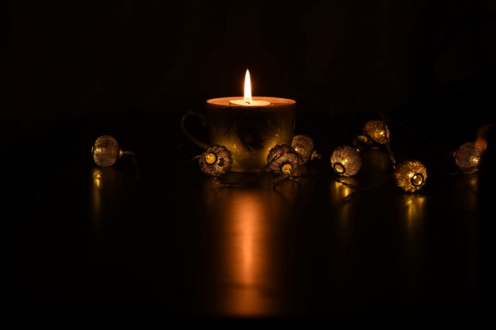 Candle in a cup with fairy lights