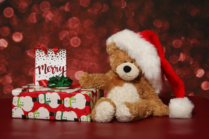 Teddy bear with Santa hat and Christmas gifts