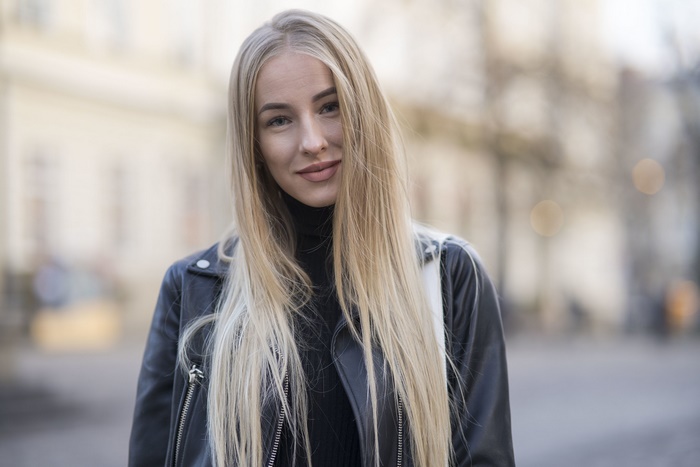 Woman with blonde hair wearing a leather jacket
