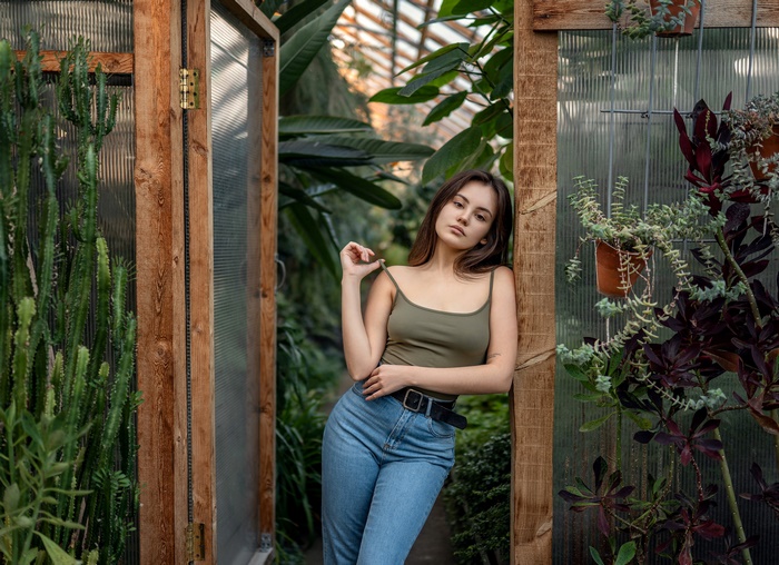 Woman in greenhouse with plants