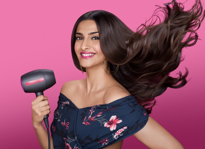 Sonam Kapoor with a hairdryer and flowing hair