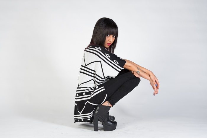 Woman with black hair and geometric print top