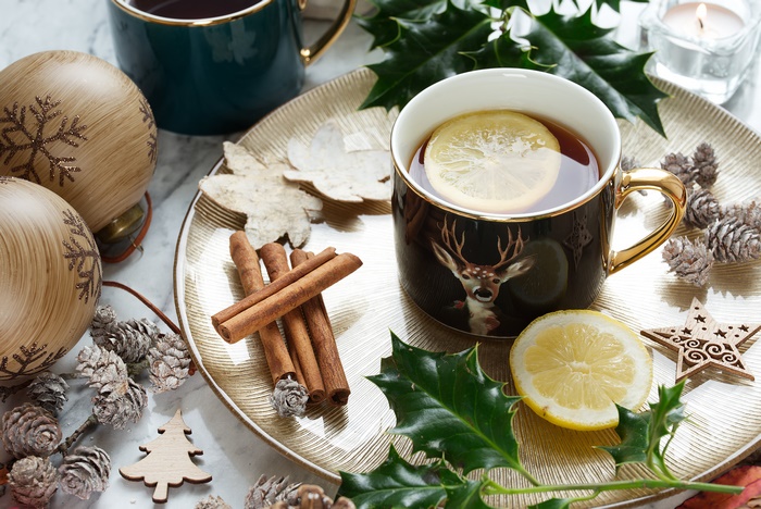 Still life with tea, cinnamon, and Christmas decorations