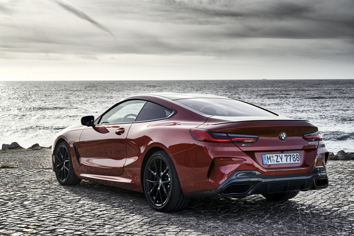 Red BMW M850i parked by the sea