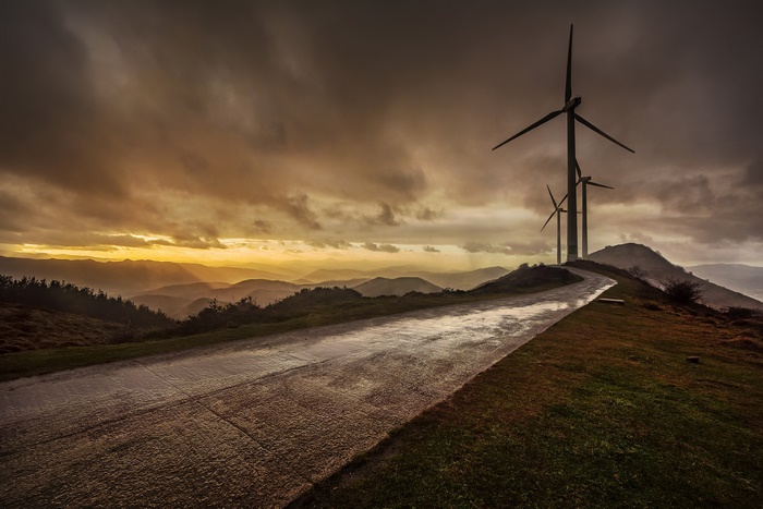 Wind turbines on a hill at sunset