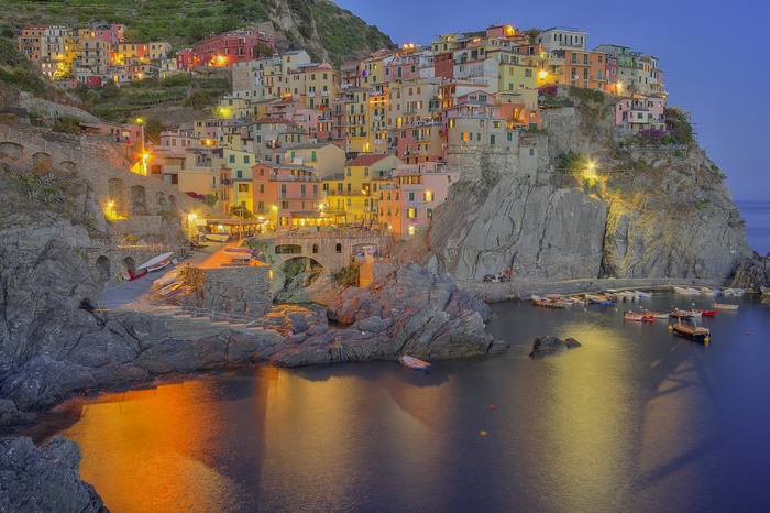 Manarola village on a rocky coast at dusk