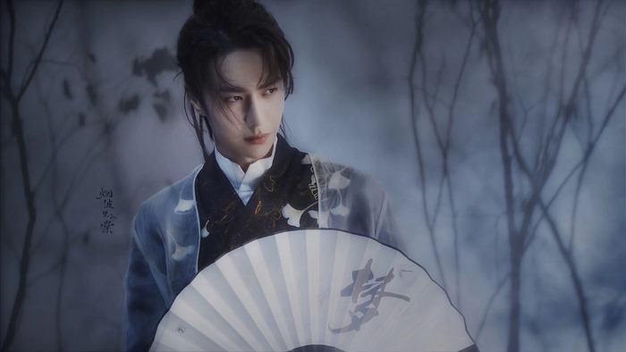 Wang Yibo in traditional Chinese attire holding a fan