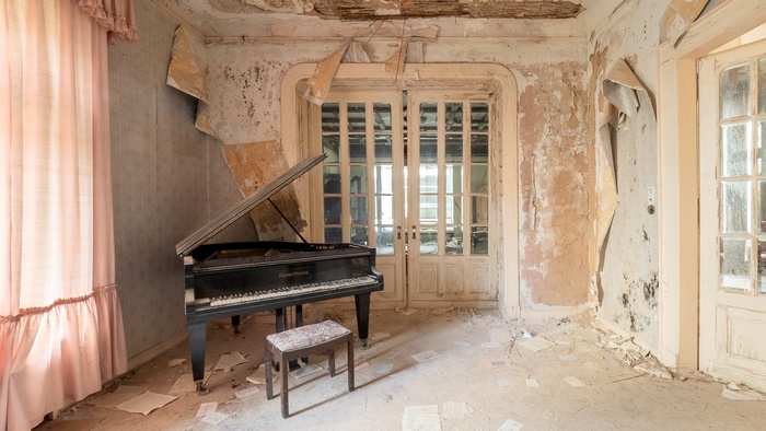 Abandoned room with grand piano and pink curtains