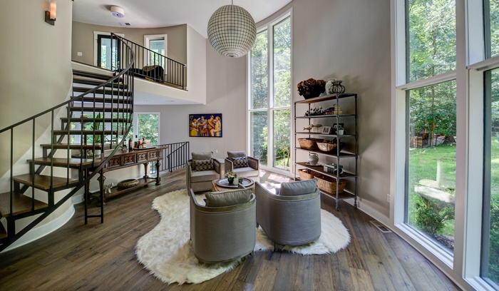 Modern living room with spiral staircase and large windows