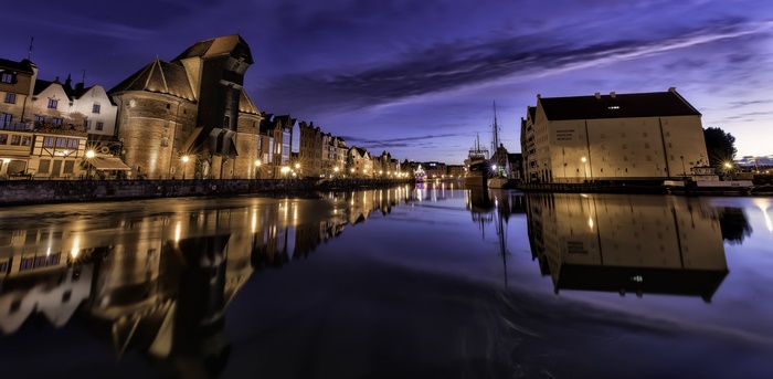 Gdansk waterfront at twilight with reflections