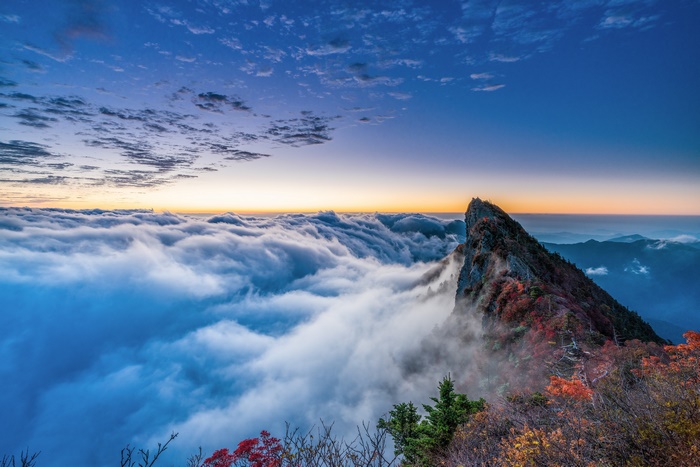 Sea of Clouds over Mountain Peak at Sunrise
