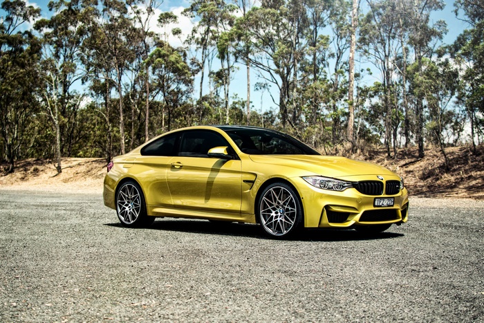 Yellow BMW M4 Coupe on a Gravel Road