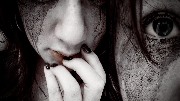 Close-up of a woman with dirt on her face
