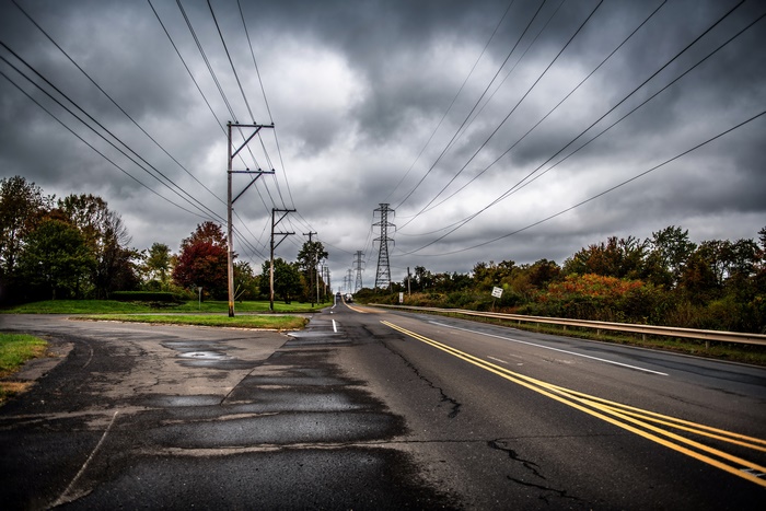 Road with power lines and autumn trees