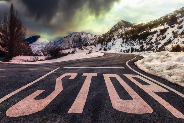 Stop Sign on Snowy Mountain Road 4K