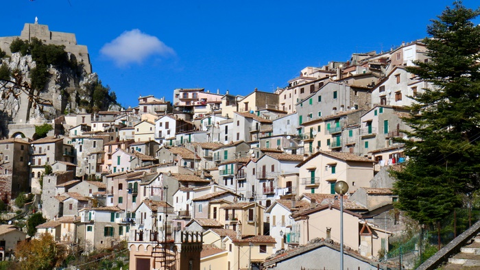 Hillside village with buildings and a fortress in Cervara di Roma, Italy