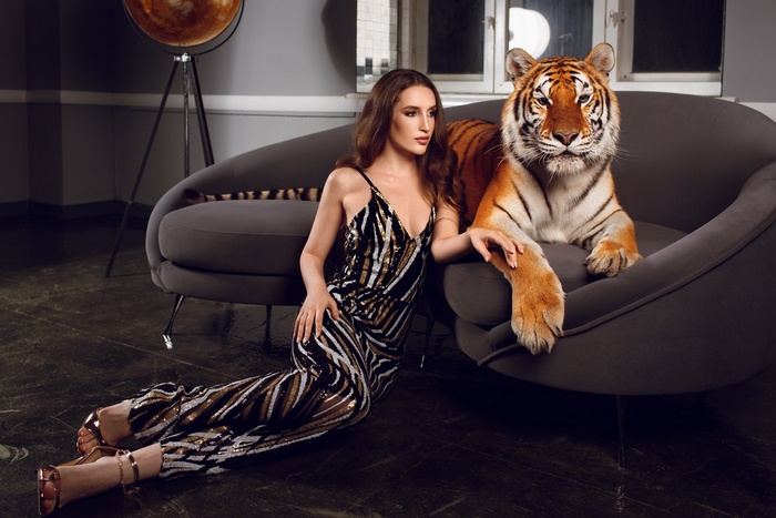 Woman and tiger on a sofa