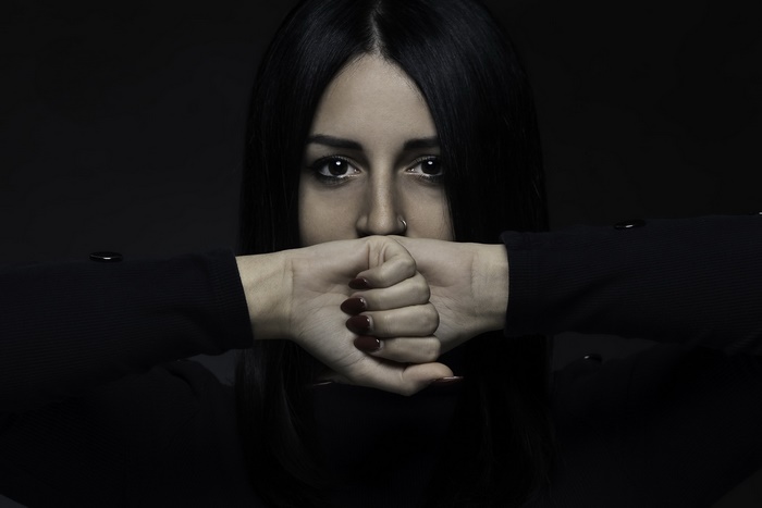 Woman covering mouth with hands