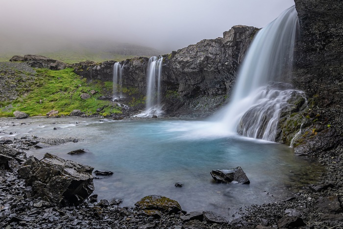 Waterfalls cascading into a blue pool in Iceland