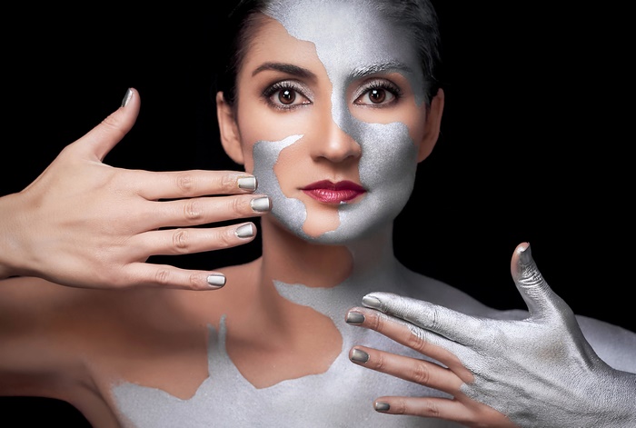 Woman with silver body paint and makeup