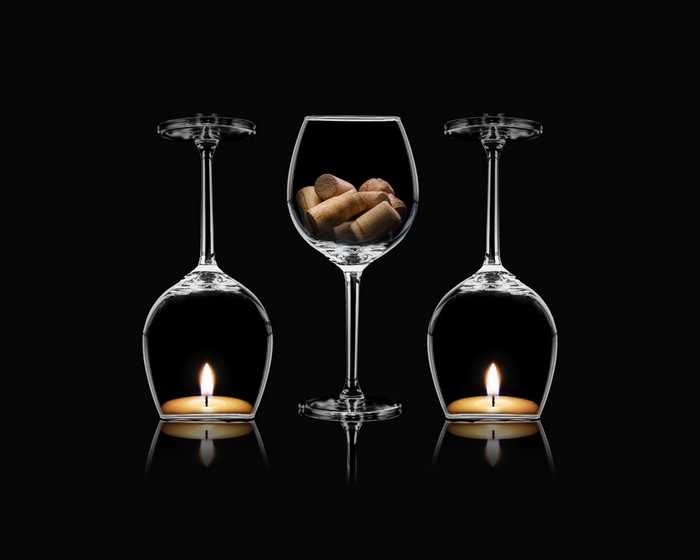 Wine glasses with candles and corks