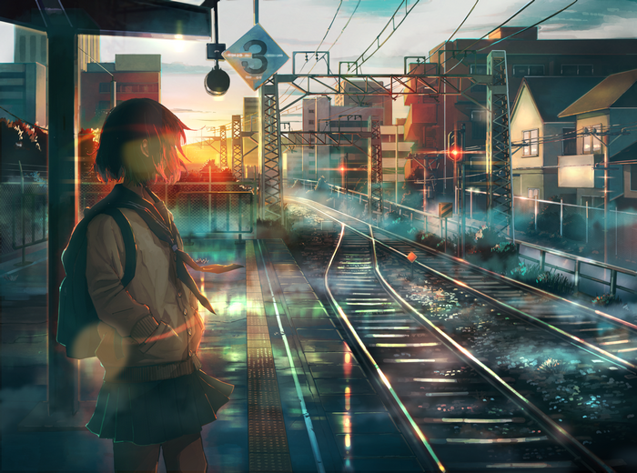Girl in uniform waiting at train station during sunset