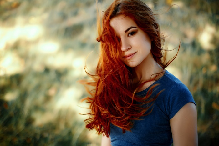 Woman with long red hair and brown eyes