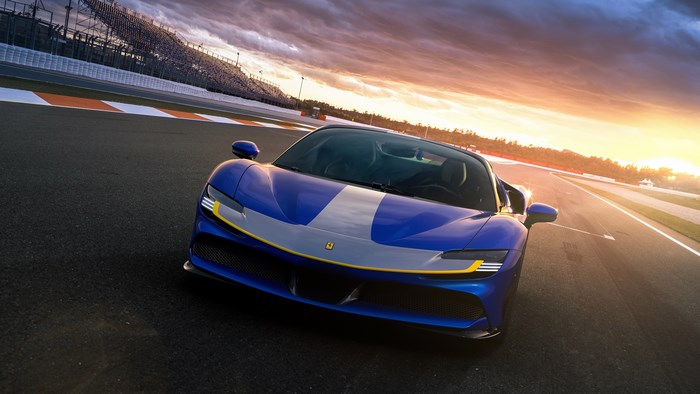 Blue Ferrari SF90 Spider on a Race Track