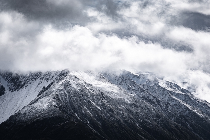 Snow-covered mountain peak with clouds