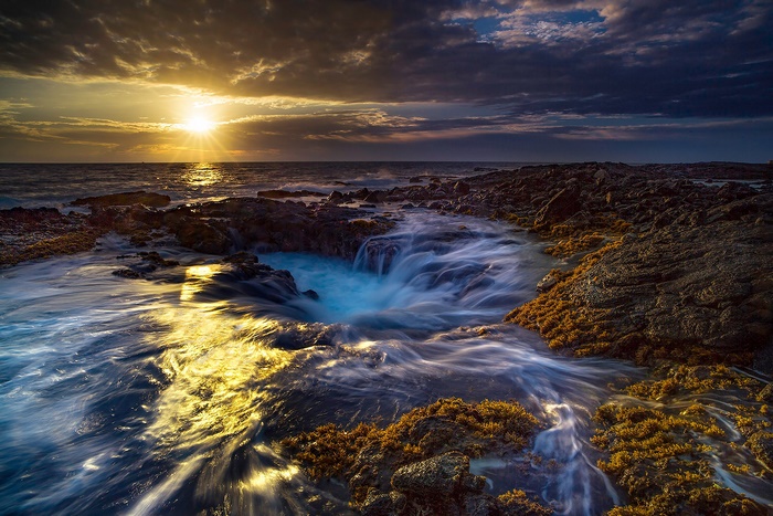 Sunset over the rocky coast of Hawaii