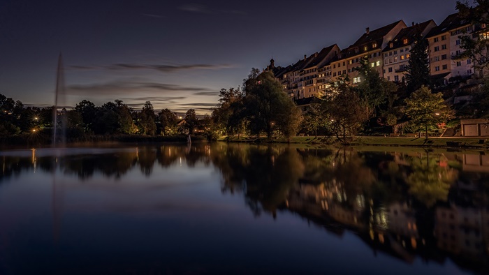 Town with lake and buildings at night
