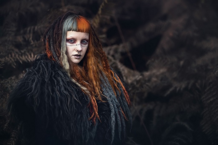 Woman with dreadlocks and face paint
